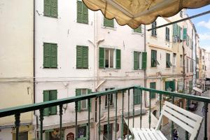 a view from the balcony of a building with green shutters at Via Corradi in Sanremo +15 photos