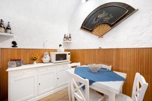 a kitchen with a white table and a microwave at Via Corradi in Sanremo