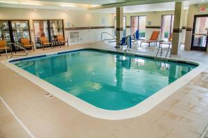 a large swimming pool in a hotel lobby at Courtyard by Marriott Rocky Mount in Rocky Mount