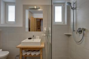 a bathroom with a sink and a shower at Schüsslerhof in Campo Tures