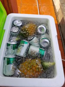 a white bin filled with drinks and fruit and cans at 1989 Villa in Việt Trì