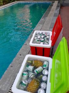 a pool with two plastic containers of drinks and food next to the water at 1989 Villa 