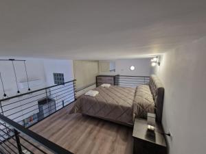 a large bedroom with a bed and a balcony at Casa MARFI in San Giorgio a Cremano