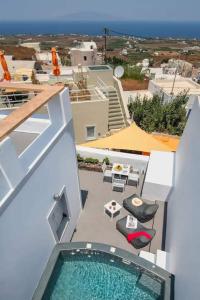 a view of a balcony with a pool on a building at Aetheria Villas in Oia
