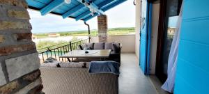 a patio with a table and chairs on a balcony at Apartman Rocky in Petrovija