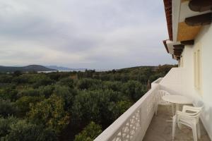 balcón con mesa, sillas y vistas en Villa Aristea en Kalo Chorio