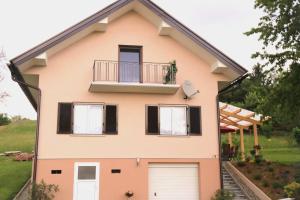 a house with a balcony and two garage doors at Ferienhaus Käfer in Steinbach
