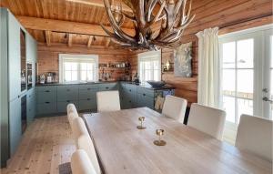 a dining room with a wooden table and chairs at Awesome Home In Rn With Jacuzzi in Ron