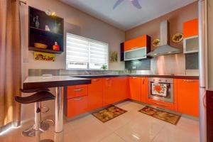 a kitchen with orange cabinets and a stove at Steps from the Sea, Side Sea-View, 3BR Sleep 6 in St. Paul's Bay