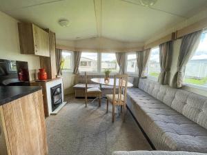 a caravan kitchen and dining room with a table and chairs at Lovely 8 Berth Caravan At Southview Park Nearby Skegness Ref 33009v in Skegness