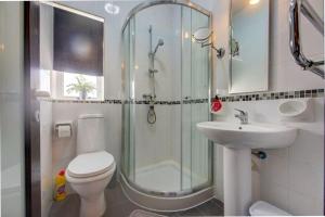 a bathroom with a shower and a toilet and a sink at Steps from the Sea, Side Sea-View, 3BR Sleep 6 in St. Paul's Bay