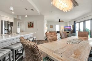 a kitchen and dining room with a wooden table and chairs at Club at Mexico Beach 2E by Pristine Properties Vacation Rentals in Mexico Beach