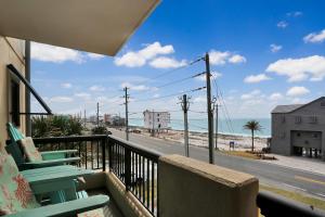 a balcony with chairs and a view of the beach at Club at Mexico Beach 2E by Pristine Properties Vacation Rentals in Mexico Beach
