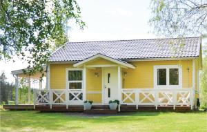 a yellow house with a white fence at Pet Friendly Home In Sunne in Älvsätern