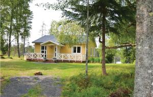 a yellow house with a dog in front of it at Pet Friendly Home In Sunne in Älvsätern