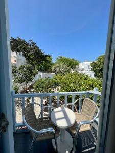 a table and chairs on a balcony with a view at Matogianni Hotel in Mýkonos City