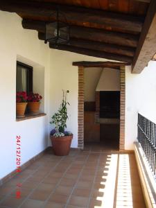 a porch of a house with potted plants on it at Casa del Abuelo 2 in Yeste
