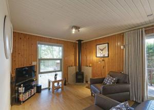 a living room with a couch and a tv at Springwood Lodges in Harrogate