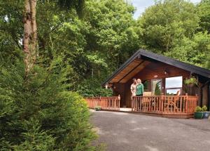 two women standing on the porch of a cabin at Springwood Lodges in Harrogate