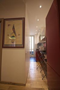 a hallway of a kitchen with a picture on the wall at Piramide House in Rome