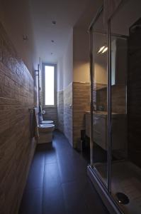 a bathroom with a shower and a toilet and a sink at Piramide House in Rome