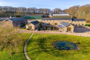 an aerial view of a farm with a building at The Hideaway - Luxury Cottages in York