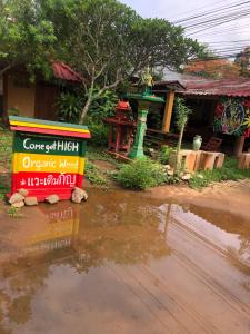 a flooded street with a sign in front of a house at Aerie Lodge in Pang Mapha