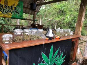 a wooden table with jars of food on it at Aerie Lodge in Pang Mapha