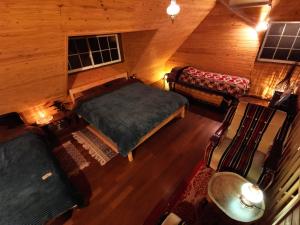 an overhead view of a bedroom with a bed and a couch at 星空に包まれる 森の隠れ家　Amrita Lodge ~stay & retreat~ in Kirishima