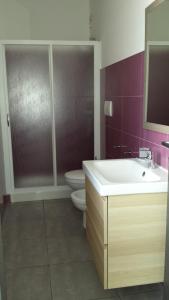 a bathroom with a sink and a toilet at Case vacanze Iris in Uggiano la Chiesa