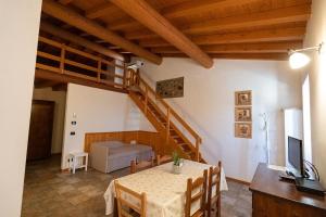 a dining room with a table and a staircase at Azienda Agrituristica Armea in Desenzano del Garda