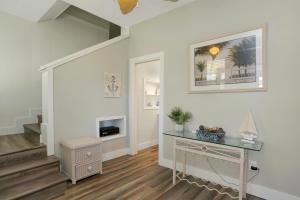 a living room with a desk and a staircase at The Shore House by Pristine Properties Vacation Rentals in Saint Joe Beach