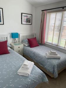 a bedroom with two beds with towels on them at 22 Salcombe Retreat Uninterrupted View to the Sea in Soar