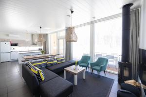 a living room with a couch and a table at Nallikari Holiday Village Villas in Oulu