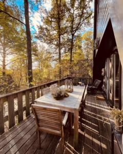 a wooden deck with a wooden table and chairs at Chalet Woods in Durbuy