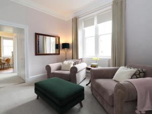 a living room with a couch and chairs and a mirror at Cameron Fell Apartment Keswick in Keswick
