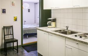 a kitchen with a sink and a room with a bed at Holiday Home Hörby Xiii in Hörby +12 photos