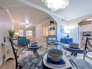 uma sala de jantar e cozinha com uma mesa de vidro em 2 Bed-1 Bath With Sunroom, Private Pool And Beach Access! em Clearwater Beach