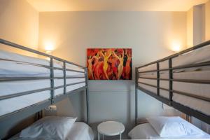 a bedroom with two bunk beds and a painting on the wall at Hotel Bristol in Luxembourg