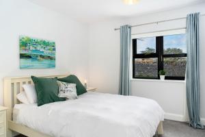 een slaapkamer met een bed en een raam bij Cottage 345 - Oughterard in Oughterard