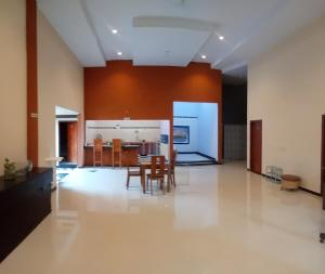 a living room with a dining room and a kitchen at Ijen Transito 2 HOMESTAY in Ketapang