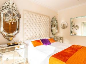 a bedroom with a large white bed and a mirror at Z&Olé in Torremolinos