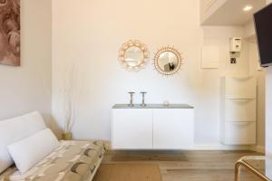 a white bathroom with a sink and a mirror at Santa Croce Top by Mmega in Florence