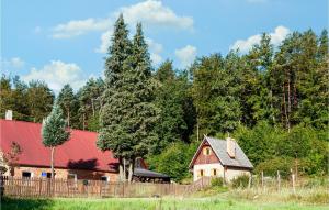 a house with a red roof and a wooden fence at Awesome Home In Wejherowo With Kitchenette in Wejherowo
