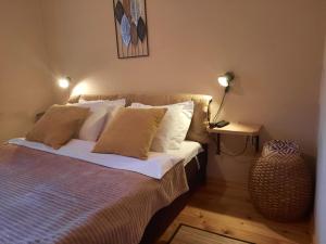 a bedroom with a bed with white sheets and pillows at Apartment Dea in Kolašin