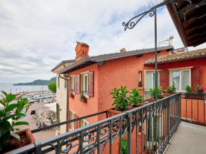 a balcony of a building with a view of a beach at Piccolo Hotel in Garda