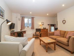 a living room with a couch and a table at Blackberry Cottage in Kingsbridge