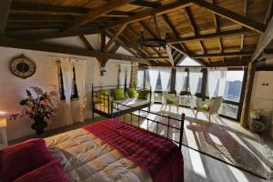 a bedroom with a large bed in a room with windows at The Stone Castle Boutique Hotel in Ağaçlı