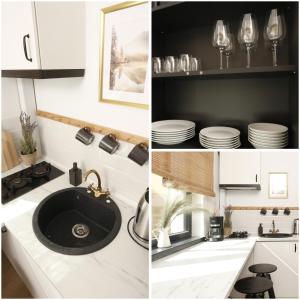 a kitchen with white cabinets and a sink and plates at Chic Concept Studio in Bucharest