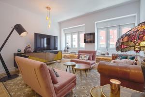 a living room with leather furniture and a flat screen tv at León CASAKALMA D. VALENTIN in León